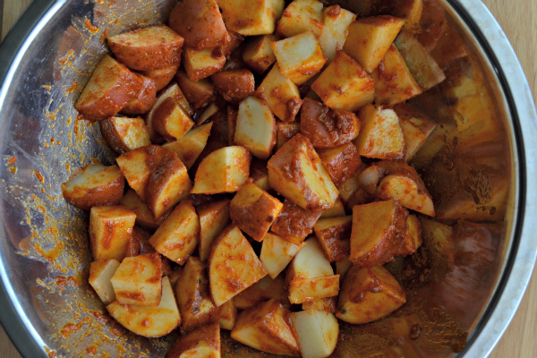 Step 2: Coat the diced potatoes in the sauce mixture