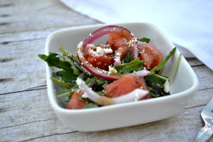 watermelon salad with arugula, feta, pickled onions and balsamic reduction