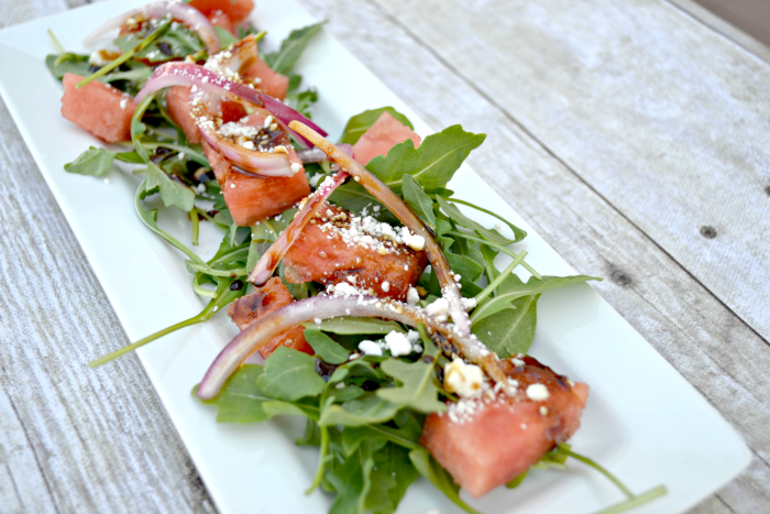 watermelon salad with feta, arugula, pickled onions and balsamic reduction